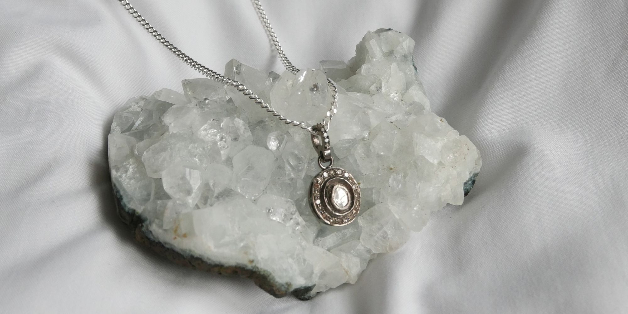 silver diamond necklace on quartz crystal